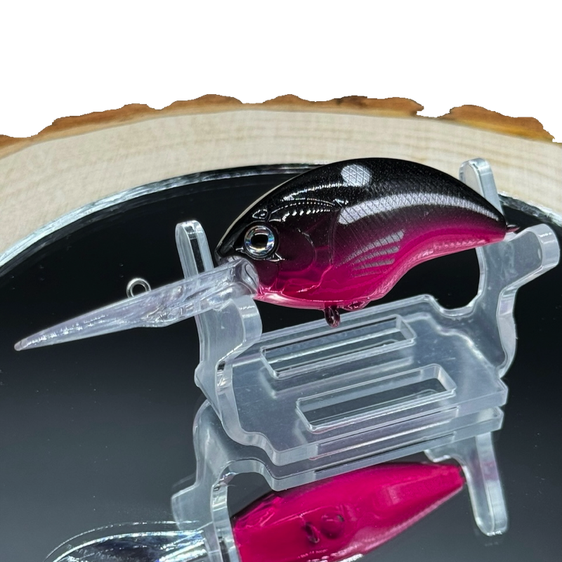 A trolling crank bait fishing lure with a black back and hot pink belly.